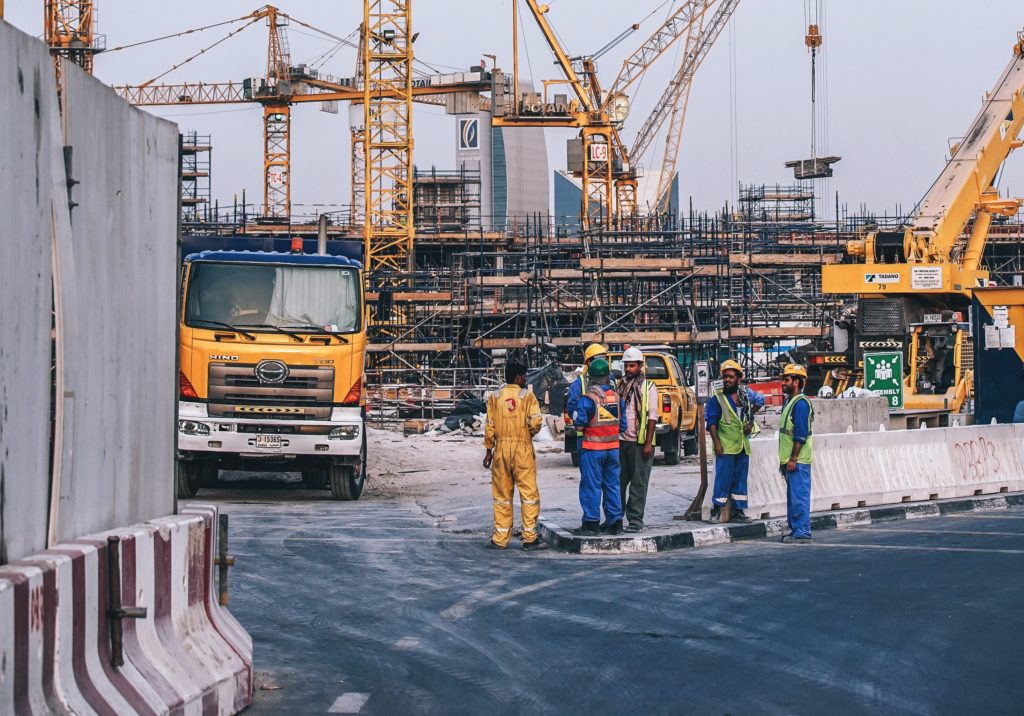 Construction site workers with cranes in Alberta
